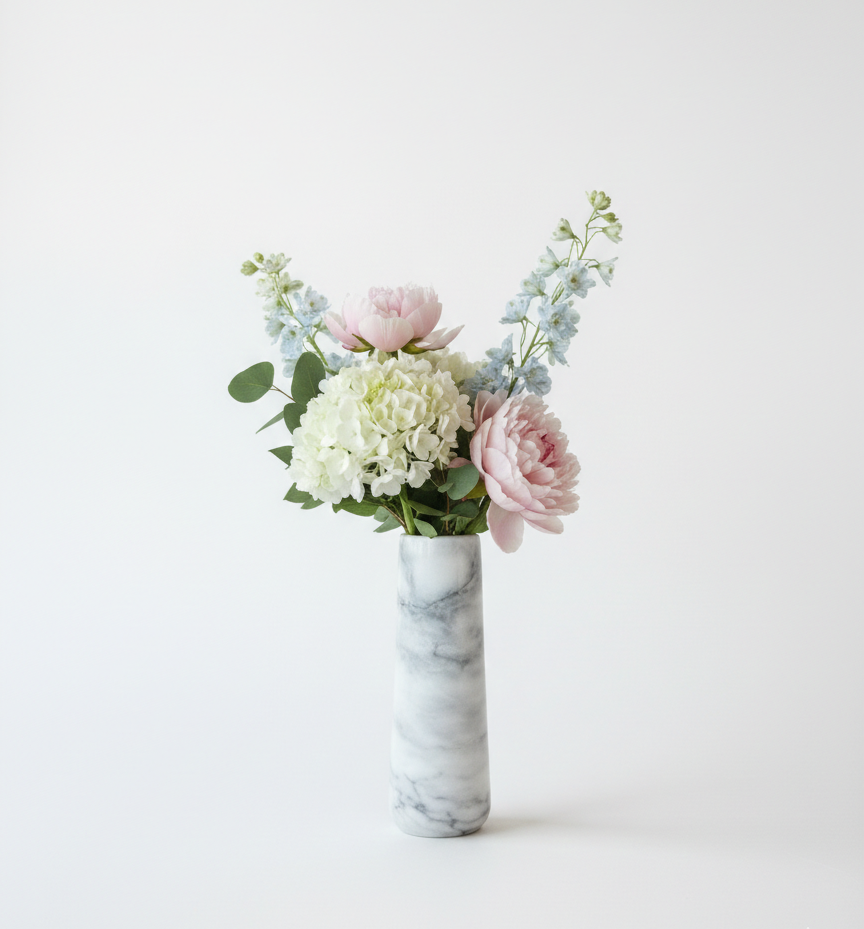 Floral arrangement in a Elba Livio marble vase on a white background